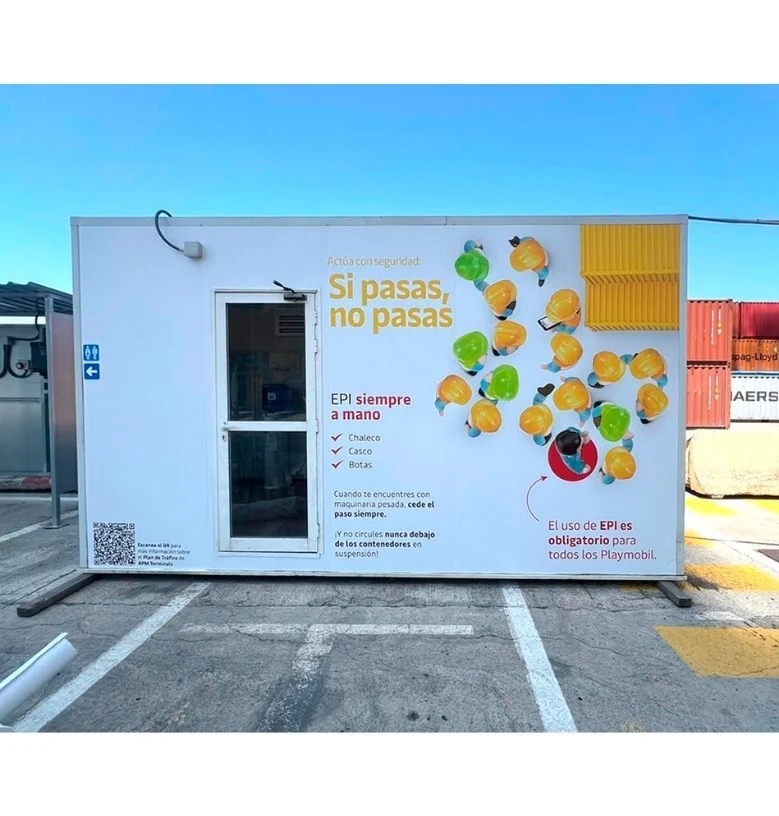 Example of creative campaigns for occupational safety with a message about the mandatory use of PPE in a construction site container.